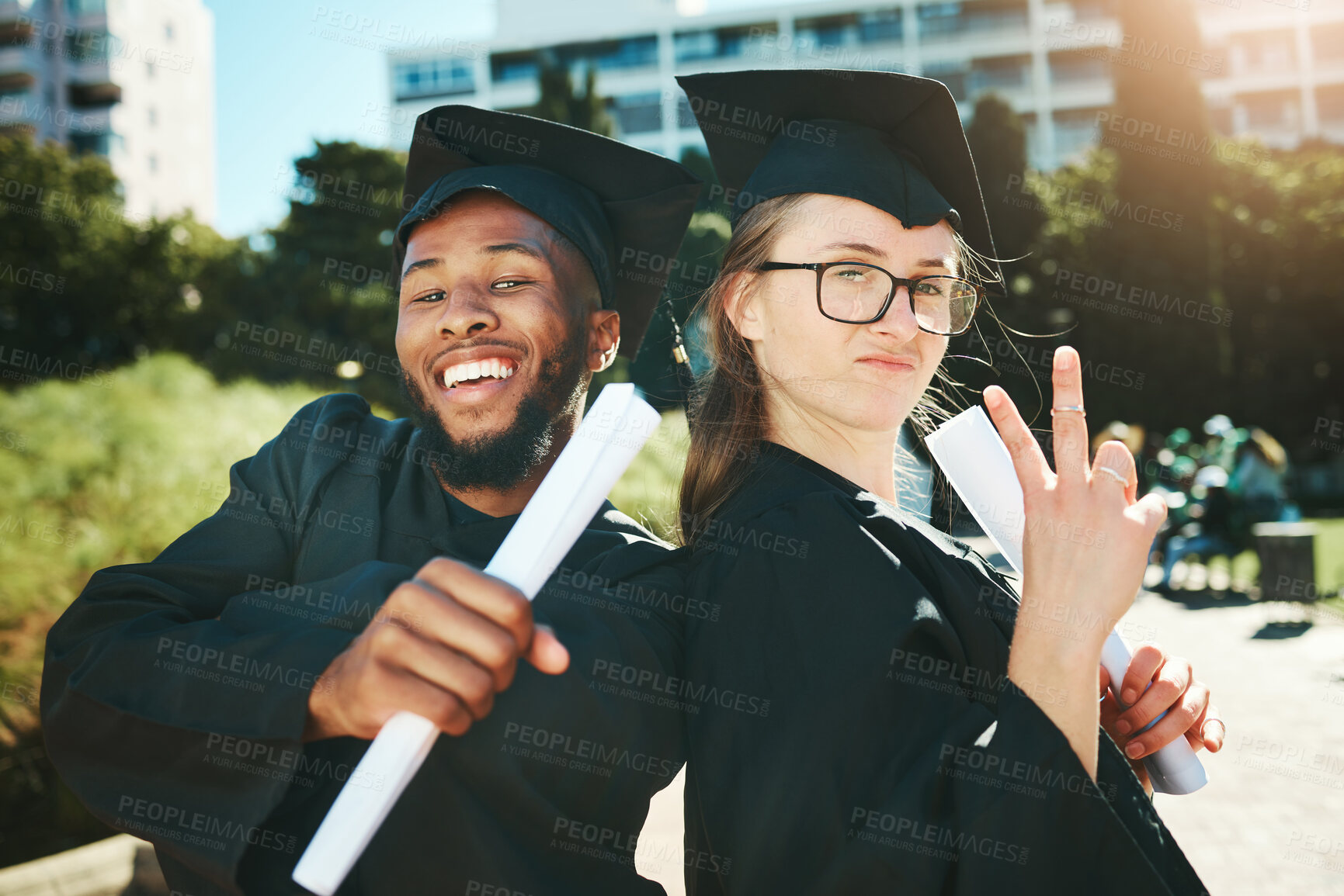 Buy stock photo Graduation, students and happy for success, achievement or silly together outdoor. Portrait, man and woman smile, for completed degree and in gown for education, certificate and diploma at university