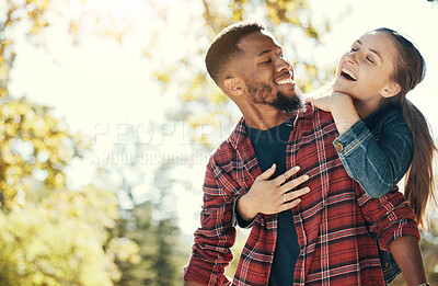 Buy stock photo Couple, hug and smile while outdoor with love and care in nature, happy together while bonding in park. Black man, woman and interracial, hugging in relationship and marriage with romance mock up.