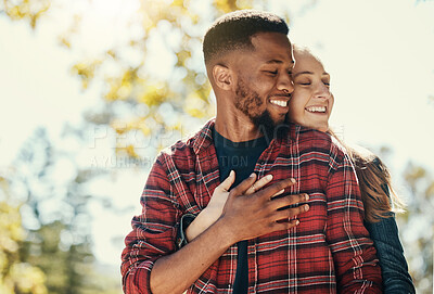 Buy stock photo Diversity, love and couple hug in nature for relax summer holiday, outdoor freedom and happy quality time. African man, woman eyes closed and happiness together, hugging and loving in nature sunshine