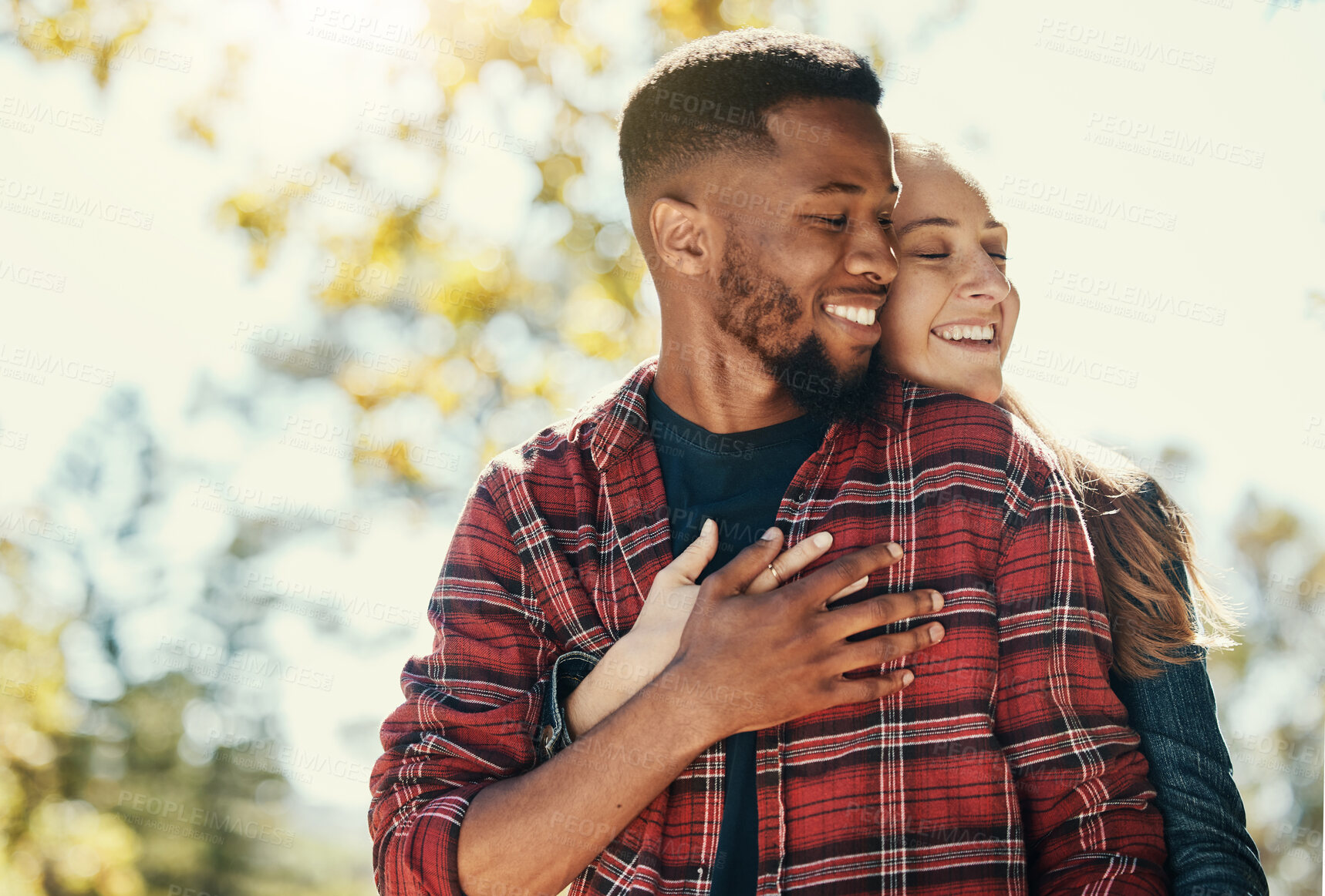 Buy stock photo Diversity, love and couple hug in nature for relax summer holiday, outdoor freedom and happy quality time. African man, woman eyes closed and happiness together, hugging and loving in nature sunshine