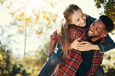 Buy stock photo Love, couple and piggy back in nature on vacation, holiday or date outdoors. Romance, diversity and happy man carrying woman on shoulders, having fun or enjoying quality time together at park outside