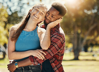 Buy stock photo Couple, love and hug outdoor, park and happy smile, romance and relax on date or care. Interracial black man and woman together, happiness or romantic affection, smiling or enjoy relationship