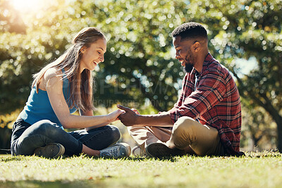 Buy stock photo Couple, park and love while outdoor in nature for freedom, support and trust in marriage partner while on grass feeling happy. Interracial man and woman together on lawn for a date and quality time