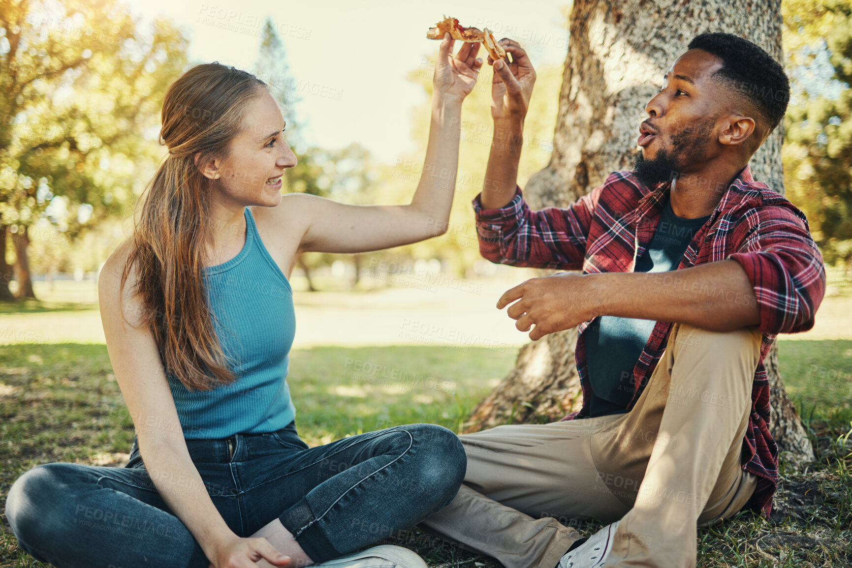Buy stock photo Relax, pizza and happy with couple in park for picnic, fast food and summer date. Love, youth and freedom with black man and woman eating lunch in grass for nature, smile and bonding together 