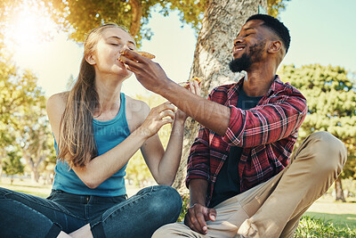 Buy stock photo Pizza, food and picnic with a diversity couple in a park during summer for a romantic date together. Fast food, eating and love with a man and woman dating or bonding in a garden for romance and fun
