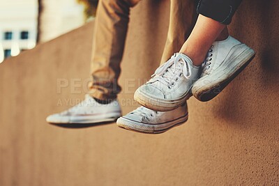 Buy stock photo People, shoes and wall with friends relax outside by city building for bonding, fun and freedom. Carefree, footwear and urban building background with people together for casual friendship 