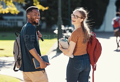 Buy stock photo Friends, students or college couple walking with books and backpack on campus for education, learning and scholarship. Portrait of interracial man and woman at university or school to study and learn