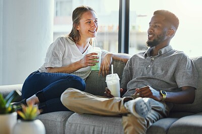 Buy stock photo Love, healthy and smoothie with a diversity couple on a sofa in the living room of their home to relax together. Weight loss, diet and nutrition with a man and woman drinking a shake for detox