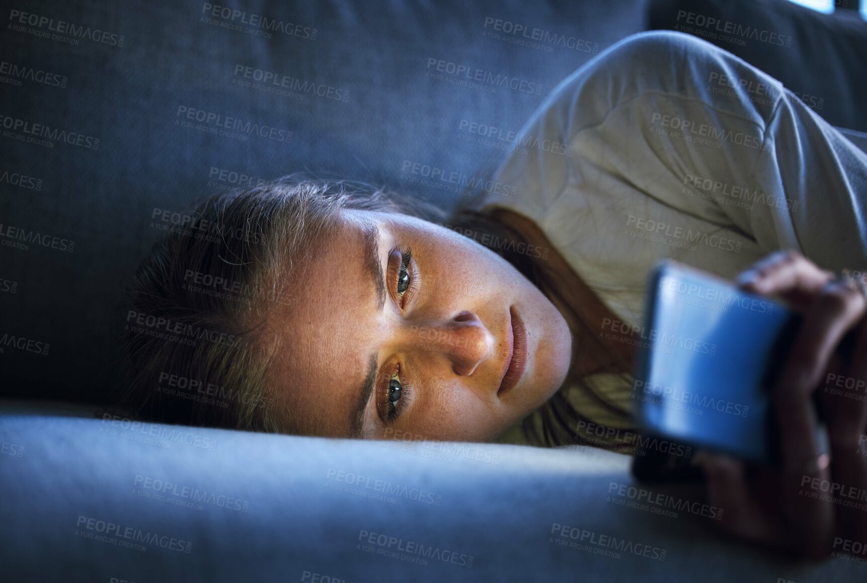 Buy stock photo Phone, night and sad woman relaxing on sofa in living room scrolling on social media after a break up. Depression, upset and girl on couch in lounge reading student loan or debt emails on smartphone.