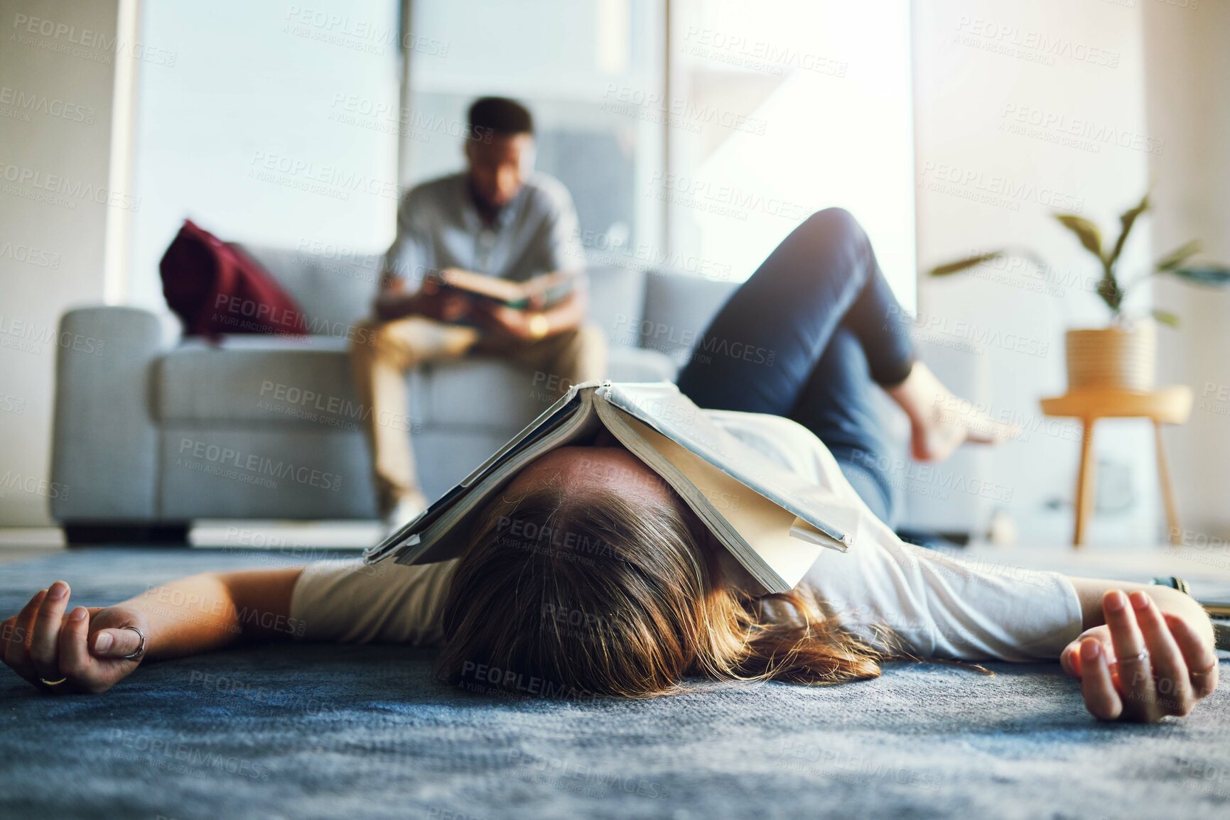 Buy stock photo Burnout, tired and student with book on face laying on floor after studying, reading and working on project. Education, university and woman exhausted, stressed and sad from college in living room