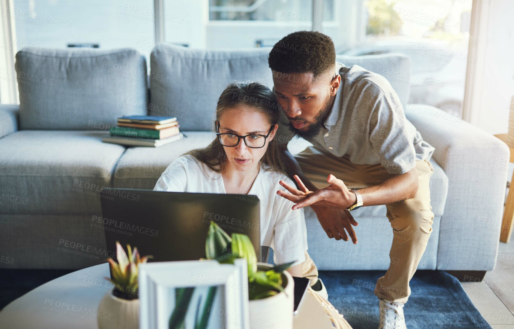 Buy stock photo Collaboration, elearning and students working on laptop in the living room of their house with technology. Interracial, couple and people planning a distance learning university project with computer