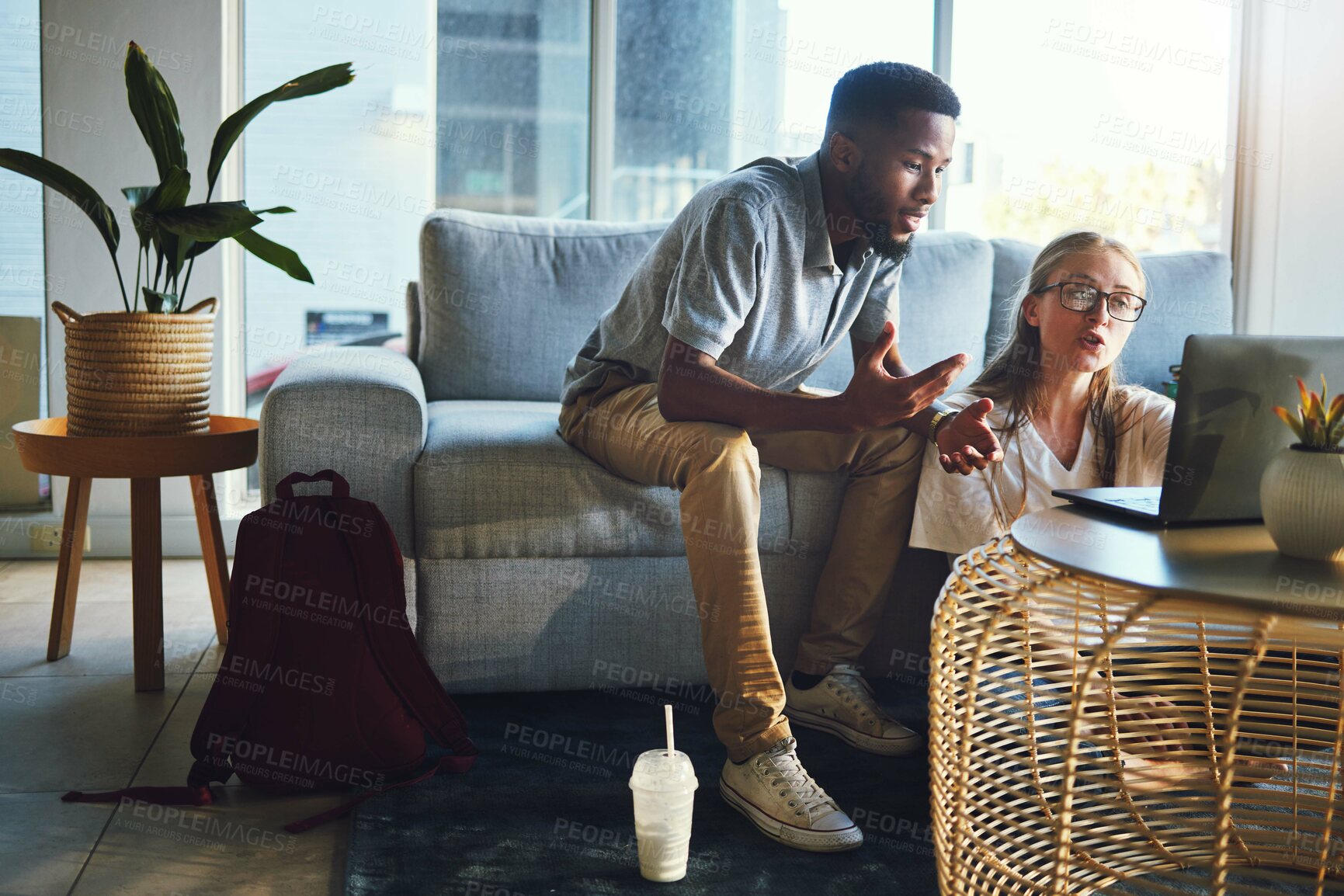 Buy stock photo Couple, laptop and debt while on living room couch talking about remote work, bill or email with home wifi. Interracial man and woman having conversation about student results on website for learning