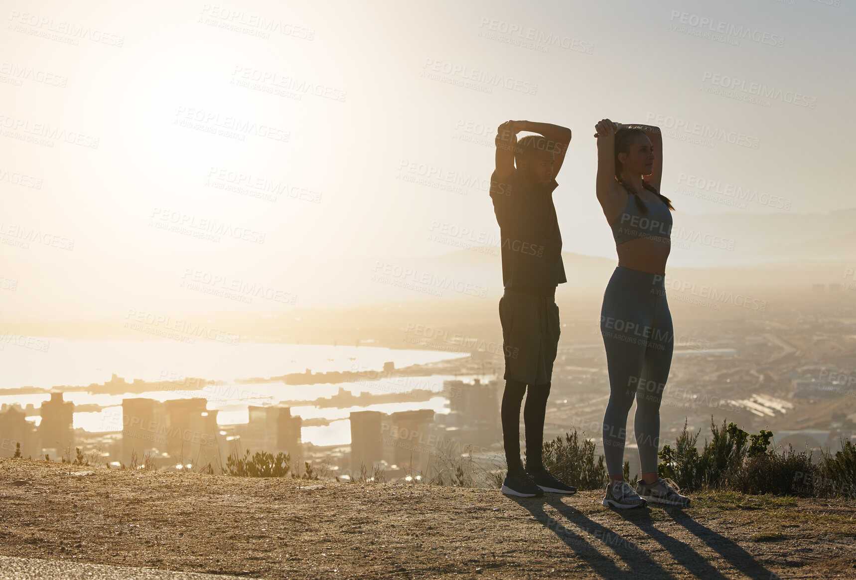 Buy stock photo Fitness, silhouette and couple stretching in city in morning for motivation, inspiration and wellness. Sports, exercise and man and woman training, workout and stretch at sunrise with city background