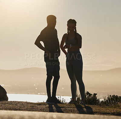 Buy stock photo Fitness, couple and checking time for running, exercise workout or sports training on a mountain in the outdoors. Man and woman silhouette in wellness for healthy run and monitoring performance