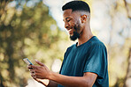 Black man with smartphone, communication outdoor with technology, message or email with 5g network in nature. Online, social media and internet connection, check cellphone and smile at meme or text.