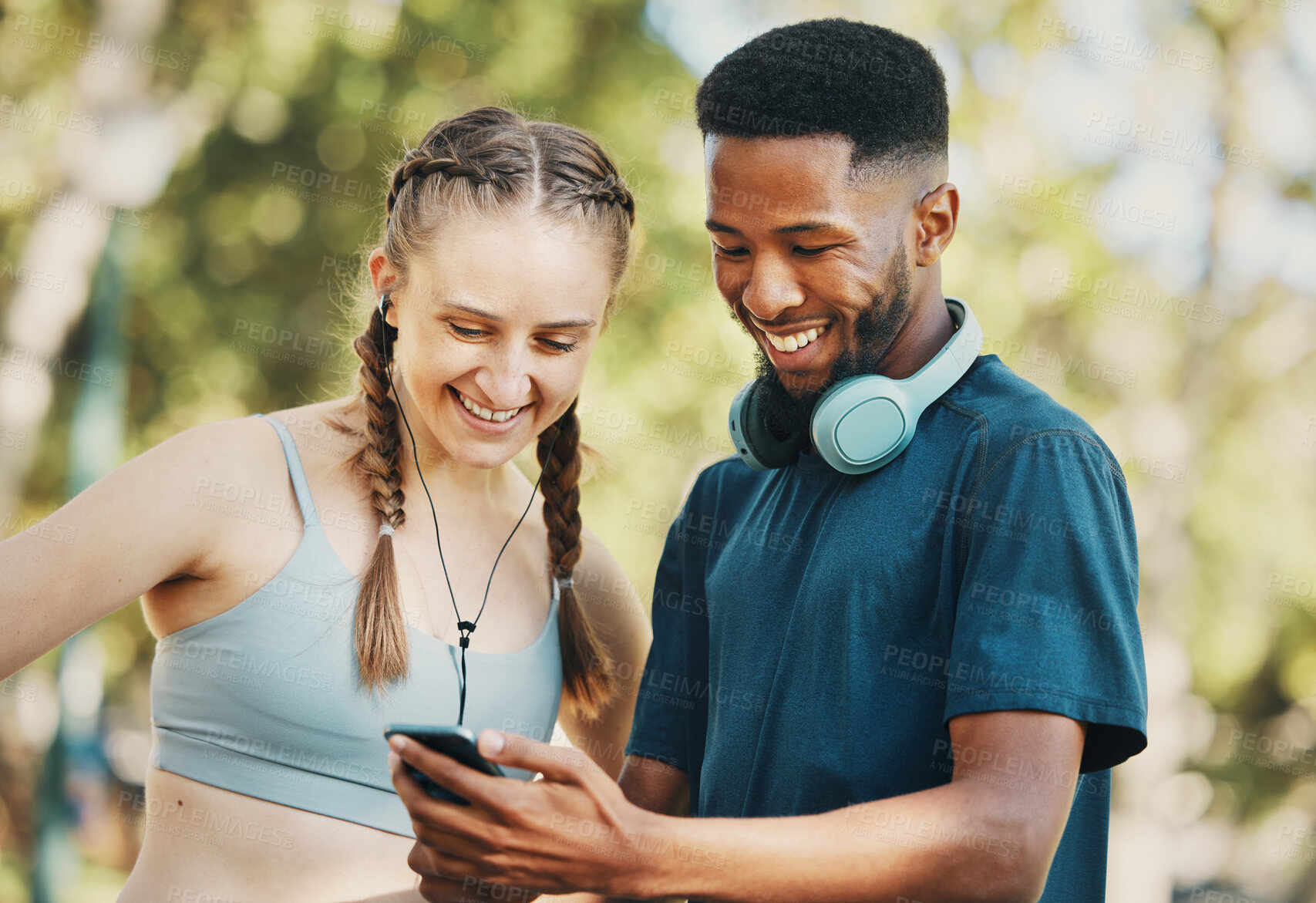 Buy stock photo Fitness, social media and couple with phone in a park for training, mobile app and funny video. Communication, comedy and black man and woman reading about a cardio workout on a mobile in nature