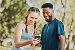 Phone, music and fitness with a diversity couple streaming audio while running in the park for exercise. Nature, social media and workout with a sports man and woman listening to the radio together
