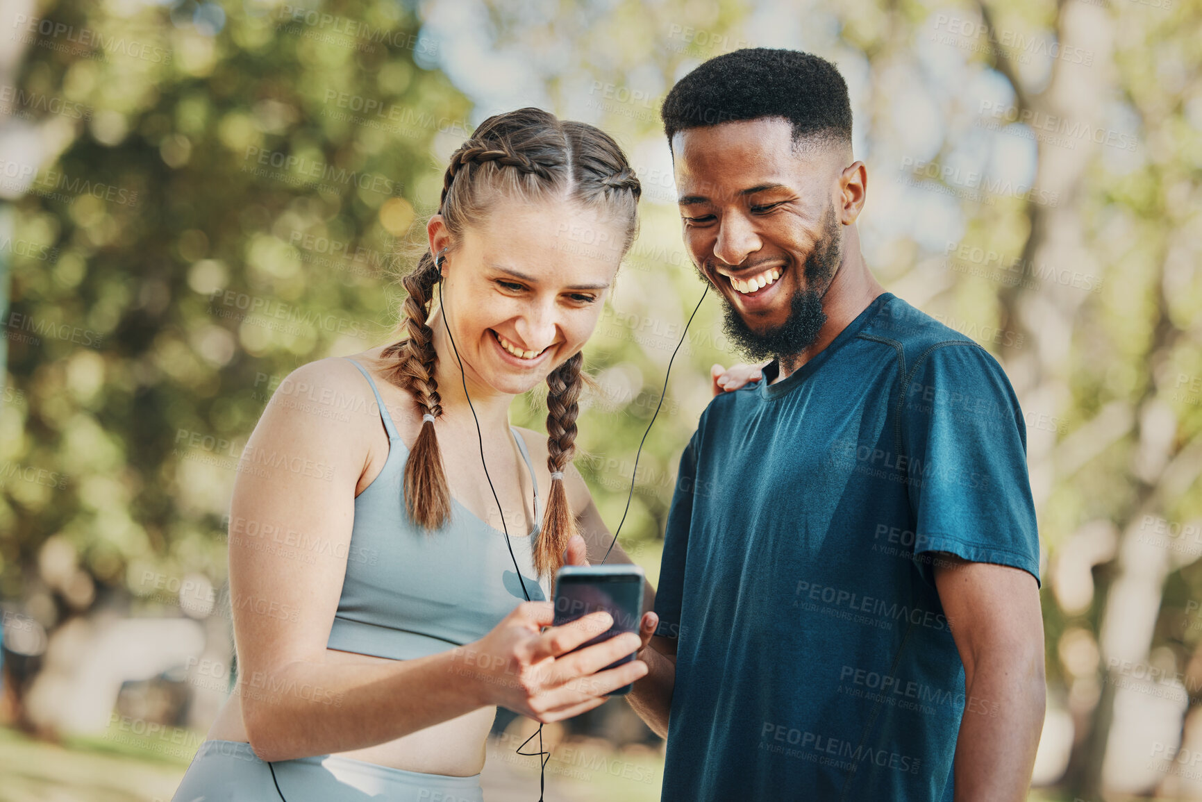 Buy stock photo Phone, music and fitness with a diversity couple streaming audio while running in the park for exercise. Nature, social media and workout with a sports man and woman listening to the radio together