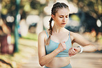 Fitness, watch monitor and workout of a woman training and checking heart pulse in a outdoor park. Runner wellness, steps and smartwatch technology app after running, exercise and sport health