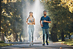 Couple are running, fitness and runner in park for exercise and cardio with body training outdoor. Run in nature, workout and healthy active lifestyle, sport with black man and woman together.