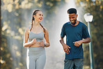Couple, running and fitness communication in nature park for exercise wellness or training workout together. Health conversation, runner motivation and diverse friends, talking on healthy cardio run
