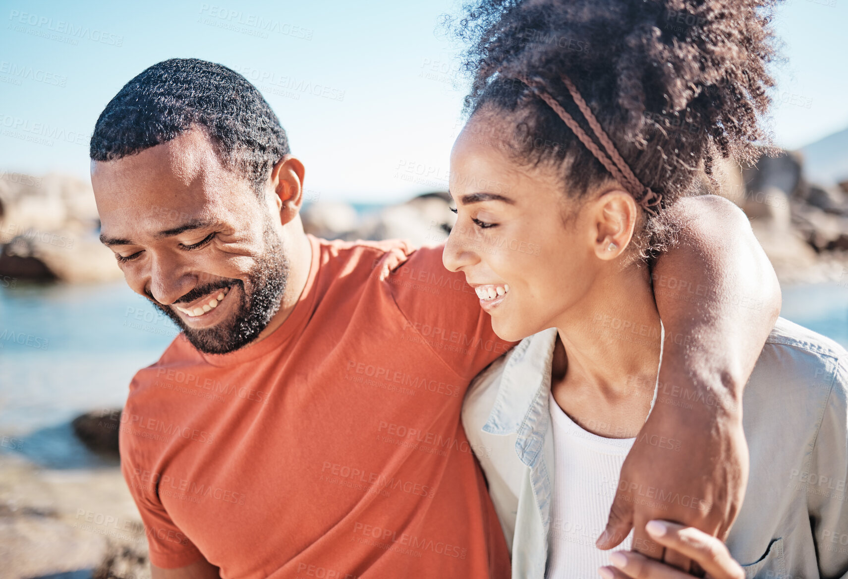 Buy stock photo Black couple, love and happiness by the beach while having funny conversation or talking about love, care and commitment on vacation in summer. Man and woman walking together by sea while on holiday