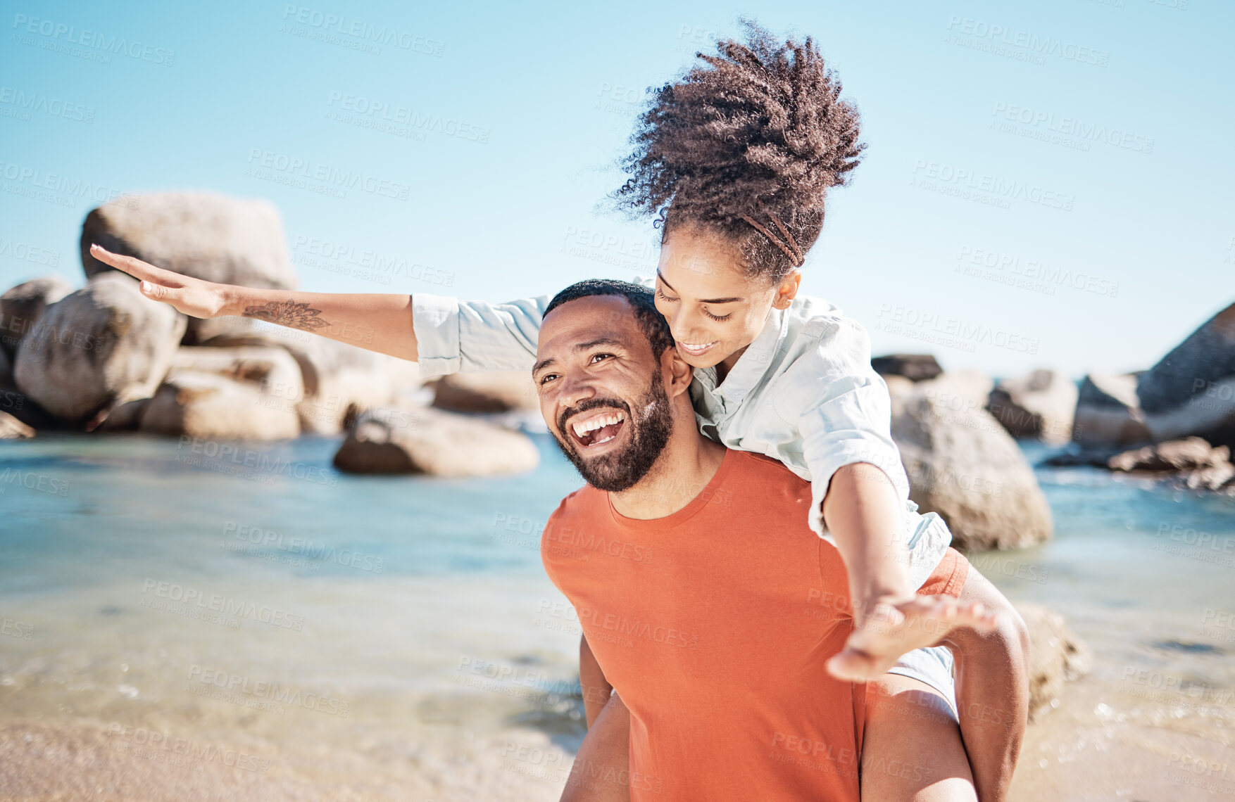 Buy stock photo Love, beach and man piggy back woman, smile and happy together for romance, holiday and vacation outdoor. Romantic, black couple and bonding being loving, enjoy seaside getaway, laugh or happiness.