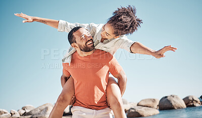 Buy stock photo Travel, happy and beach with couple and piggy back for freedom, summer and bonding. Smile, playful and airplane with man carry woman by ocean for love affection, energy and adventure on holiday 