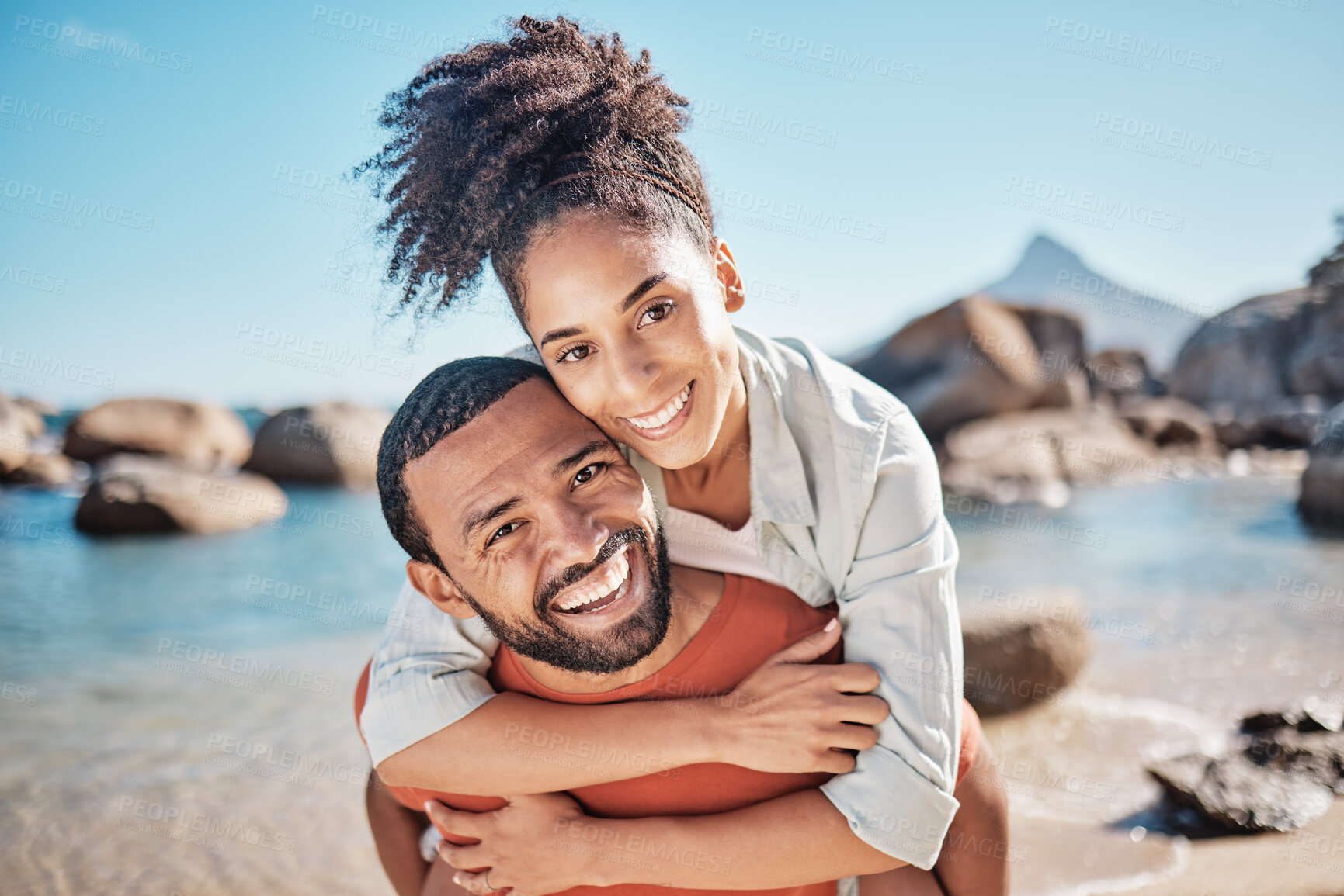 Buy stock photo Couple, piggyback or bonding on beach by ocean, sea or rock pool water in Brazilian summer holiday. Portrait, smile or happy man carrying woman in fun activity, love or support trust in nature travel