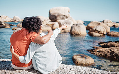 Buy stock photo Back, black couple and on beach to relax, on holiday and happy together for date, romance and embrace outdoor. Love, man and woman travel, on seaside vacation and romantic for view and happiness.