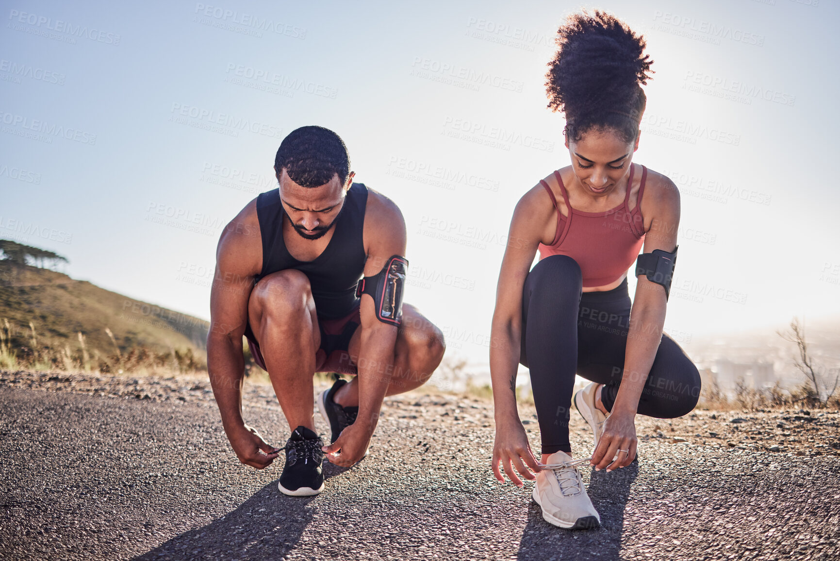 Buy stock photo Fitness couple, running shoes and exercise on a road outdoor for cardio workout and training together for health and wellness. Black woman and man tying shoelace or sneakers for a agile run