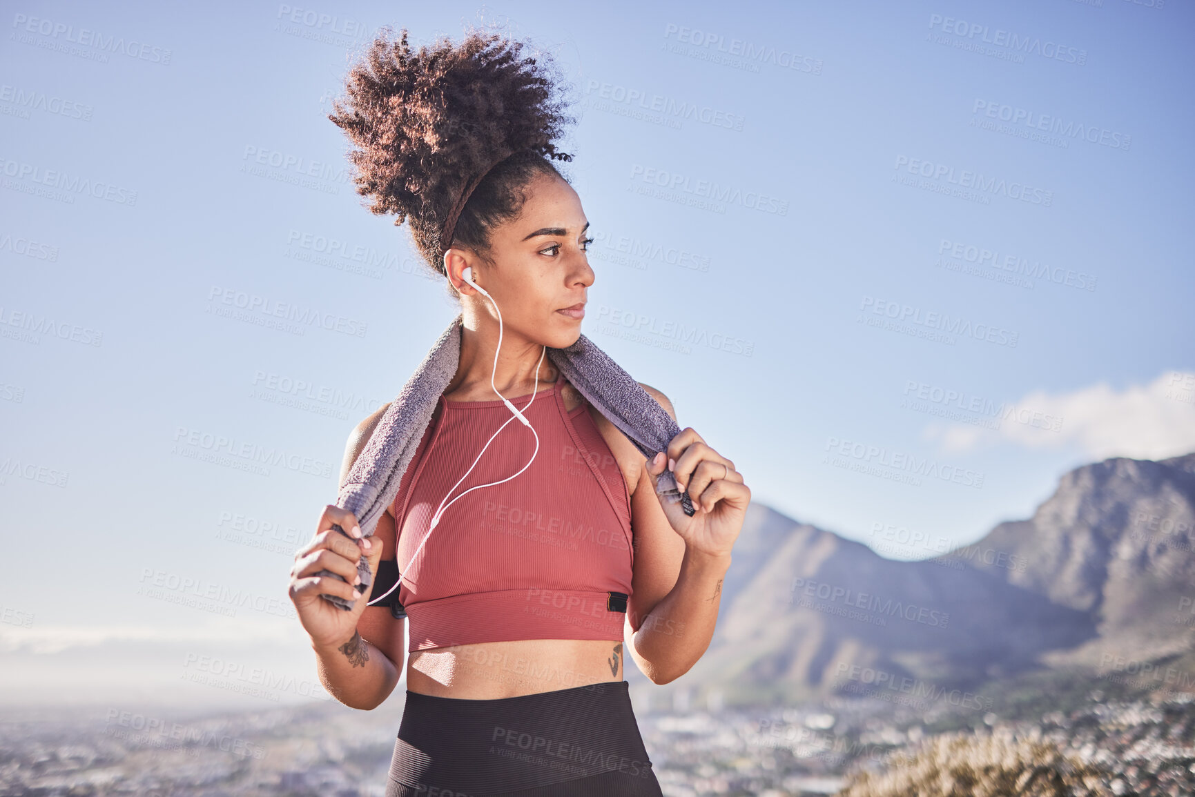 Buy stock photo Fitness, towel and black woman with earphones in nature after running, workout or training. Health, wellness or female streaming music, radio or podcast, audio or song on break after exercising alone