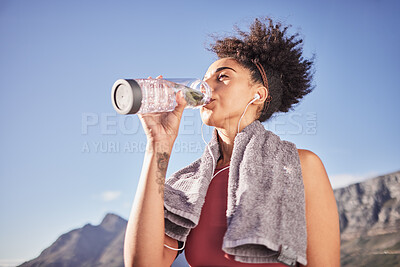 Buy stock photo Music, drinking water and woman in nature for fitness, training and morning cardio run along mountain with mockup. Podcast, water and black woman relax after running with radio, wellness and track