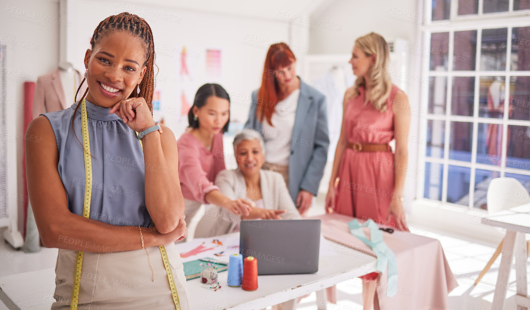 Buy stock photo Portrait, designer and fashion with a black woman seamstress standing in her workshop with a team. Fabric, creative and tailor with a female design creative in a studio with a tape measure