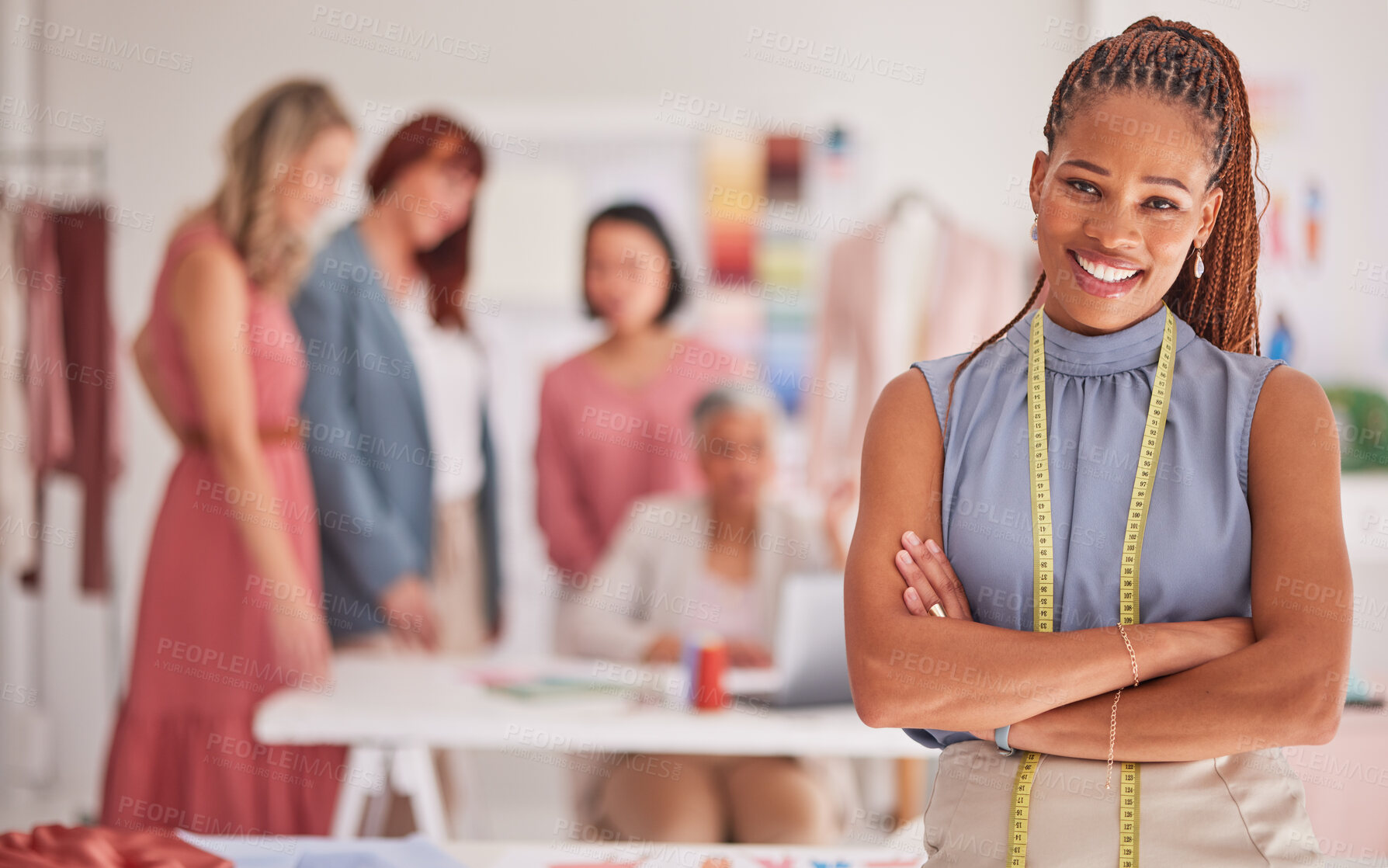 Buy stock photo Seamstress, fashion and creative with a black woman designer standing arms crossed in her office with colleagues. Portrait, workshop or measuring tape with a female design employee and team at work