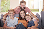 Family, hug and living room sofa with a mother, father and children smile with parent love and care. Portrait of a dad, mom and kids with happiness bonding at home together relax in a lounge