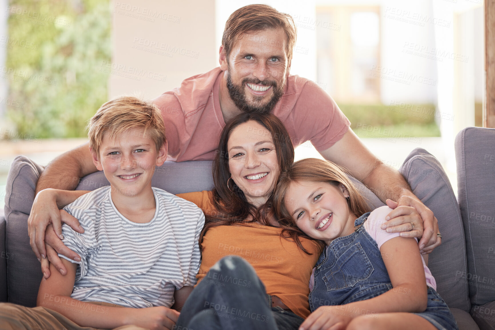 Buy stock photo Family, hug and living room sofa with a mother, father and children smile with parent love and care. Portrait of a dad, mom and kids with happiness bonding at home together relax in a lounge