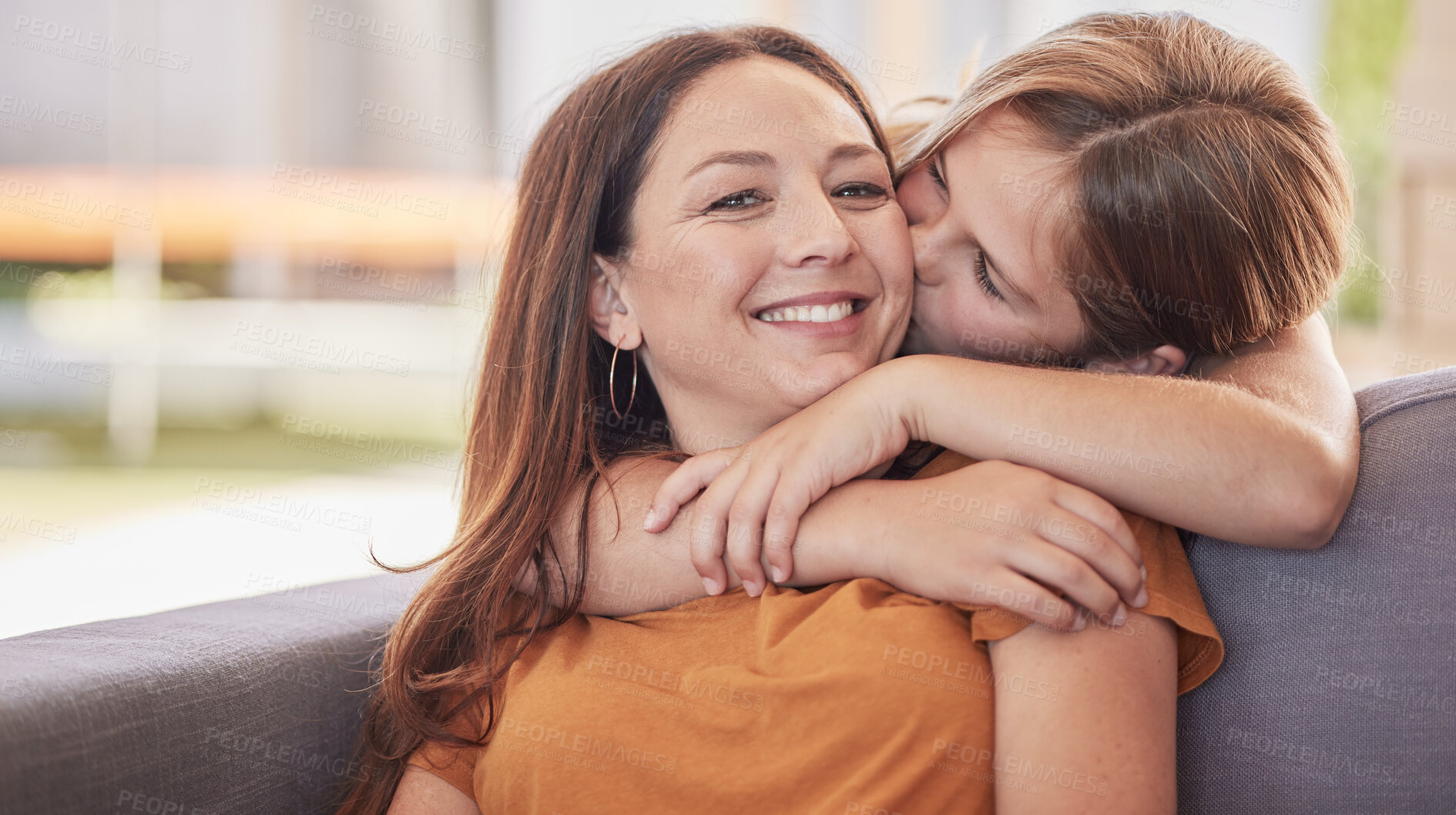 Buy stock photo Family, kiss and girl with mother on a sofa for hug, love and sweet moment in a living room together. Portrait, happy family and mom with daughter on a couch, embrace and enjoy quality time at home