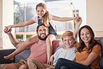 Family, love and relax on a sofa by children with parents in living room, happy and smile while bonding in their home. Portrait, happy family and kids with mom and dad in lounge, cheerful and playful