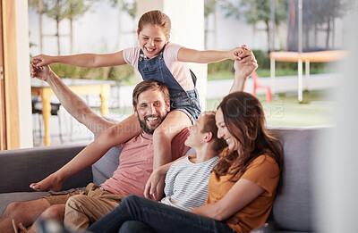 Buy stock photo Happy family, smile and love, playing and sofa for quality bonding or relaxing together at home. Mother, father and children smiling for joy in playful fun and family time on the living room couch