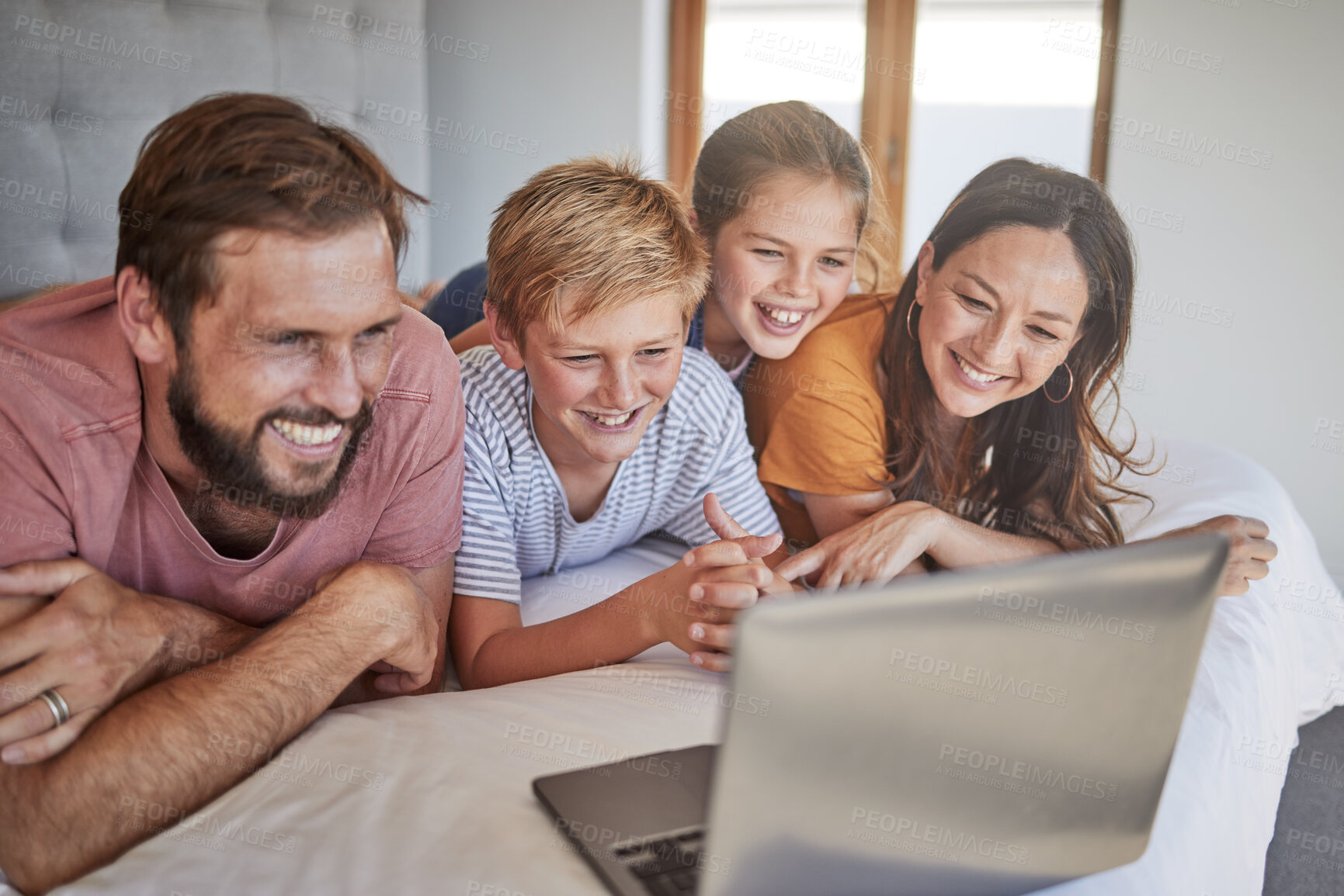 Buy stock photo Laptop, family and children with a mother, father and kids bonding while watching a movie in a home bedroom. Computer, bed and streaming with a brother, sister and parents spending time together