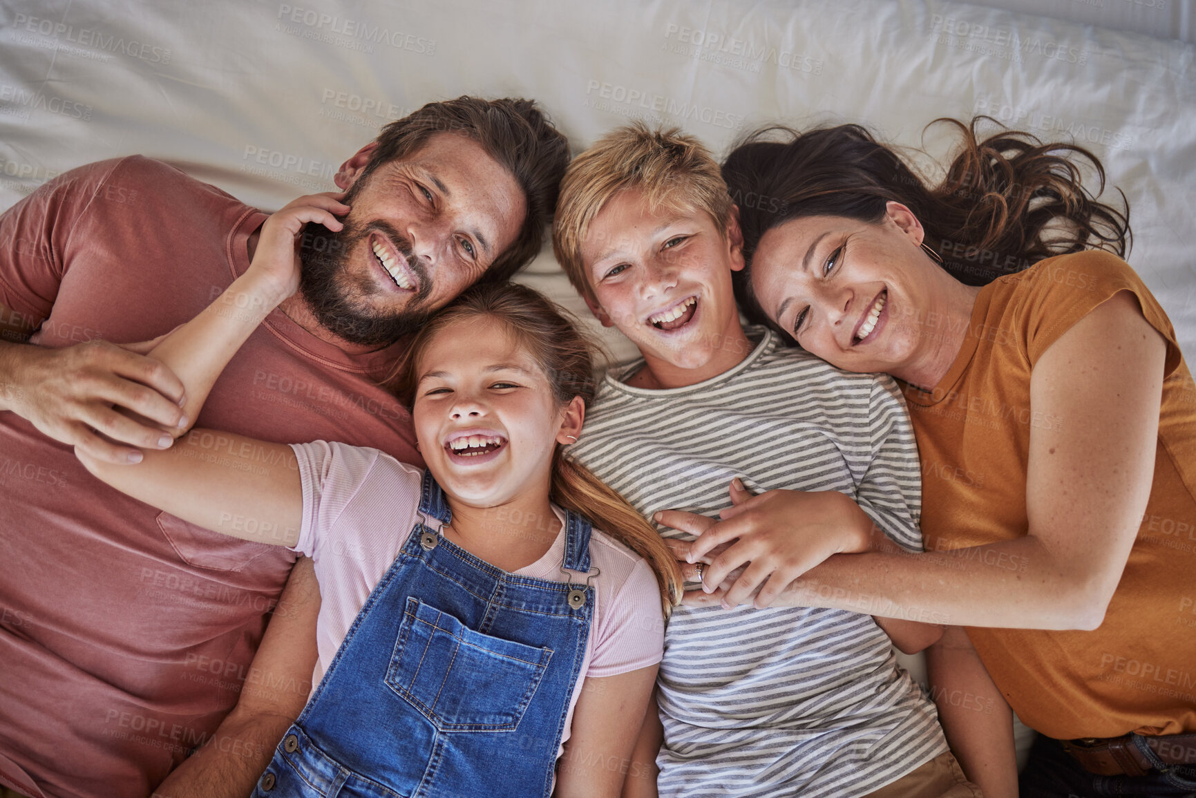 Buy stock photo Family, bed and happy portrait above in morning bonding, love or care for children in family home. Mom, dad and kids in bedroom with happiness, holiday or vacation to rest, relax or smile together