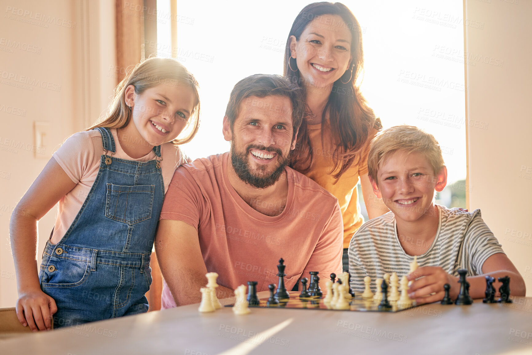 Buy stock photo Chess, game and family playing, learning and teaching in the living room of their house together. Games, happy and portrait of parents with their children and a board game competition in their home