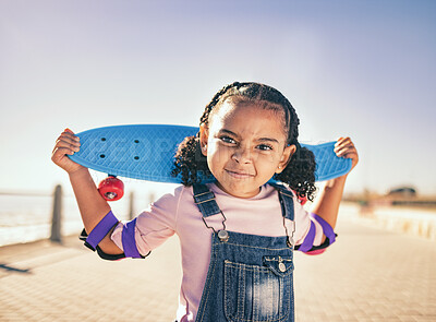Buy stock photo Skateboard, portrait and girl child at the beach promenade for skating practice on an outdoor promenade. Sports, training and kid with comic face while skateboarding by the ocean on seashore vacation