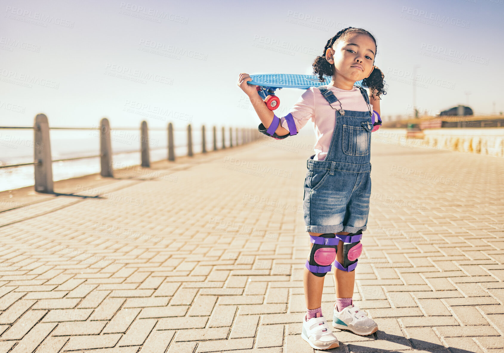 Buy stock photo Young girl, skateboard and ocean walk of a child holding a board to skate by the beach. Kid portrait of a skateboarder with a grunge pose ready for summer activity, freedom and outdoor youth fun