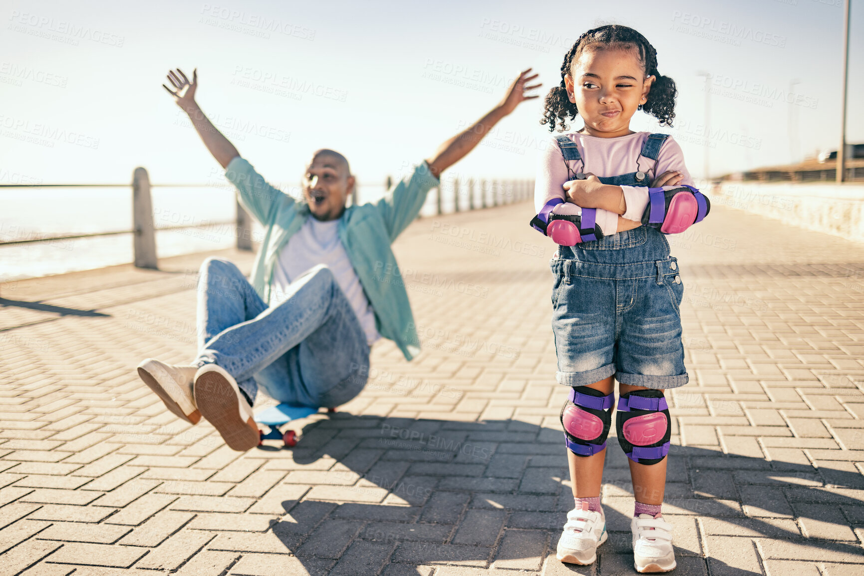 Buy stock photo Black family, children and skate boarding with a cute girl and father playing together on the promenade of a beach in summer. Skateboard, kids and love with a daughter waiting for a skateboard chance