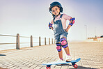 Summer, happy and little girl portrait with skateboard for holiday in Los Angeles with sky mockup. Vacation, sidewalk and cute black child with helmet ready to skate for wellness, health and fun.
