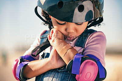 Buy stock photo Children, skater and plaster with an injured girl looking at her sore arm while skating outdoor in a helmet and pads. Training, safety and injury with a female kid in pain after a sports accident