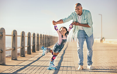 Buy stock photo Skating, learning and father holding hands of his child while teaching her on the beach promenade. Family, love and dad helping his young girl kid for support, balance and care to outdoor rollerskate