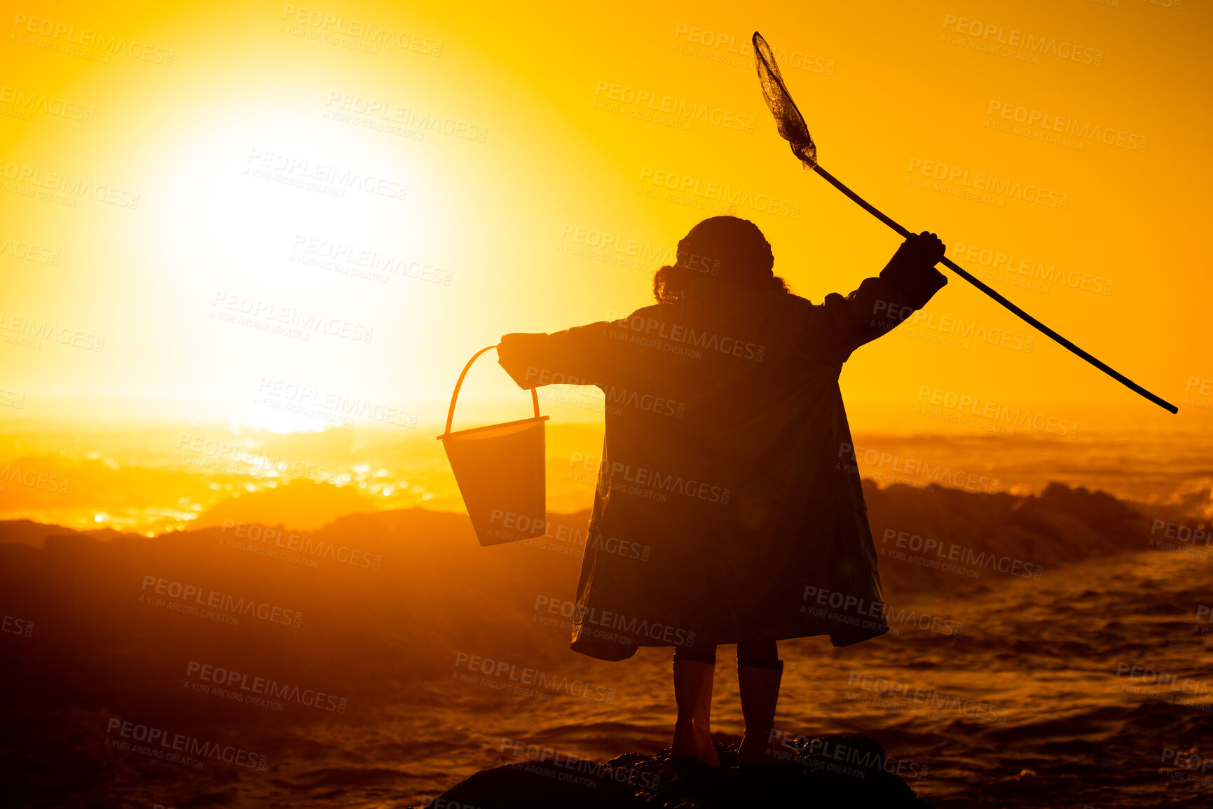 Buy stock photo Silhouette, sunset and child at beach with toys for travel, holiday and playing by water in Australia. Earth day, ocean and back of girl kid in the dark during sunrise to play and relax on vacation